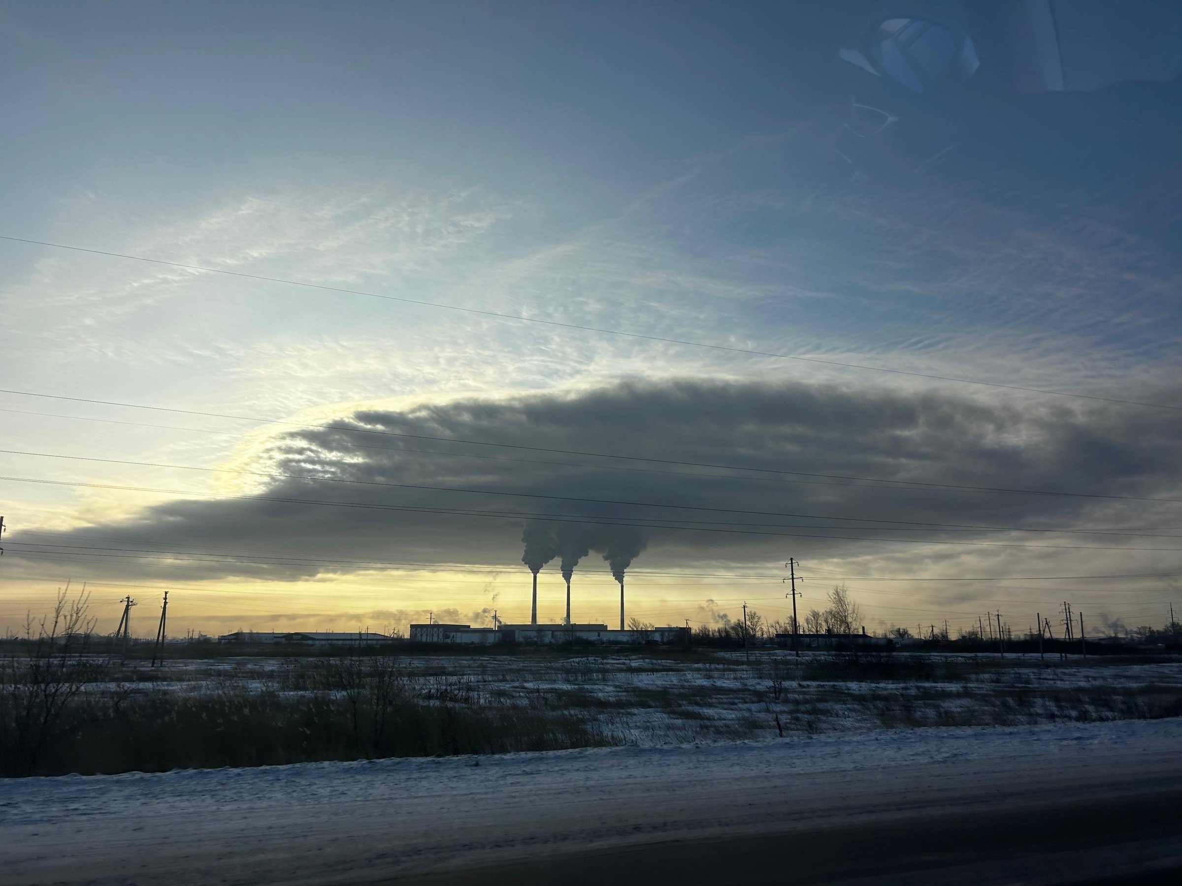 A broad plume moving across the sky from three coal-fired power-plant stacks at Petropavl, Kazakhstan.