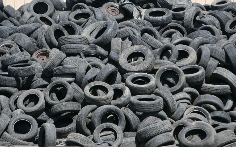 A dense pile of discarded vehicle tyres.