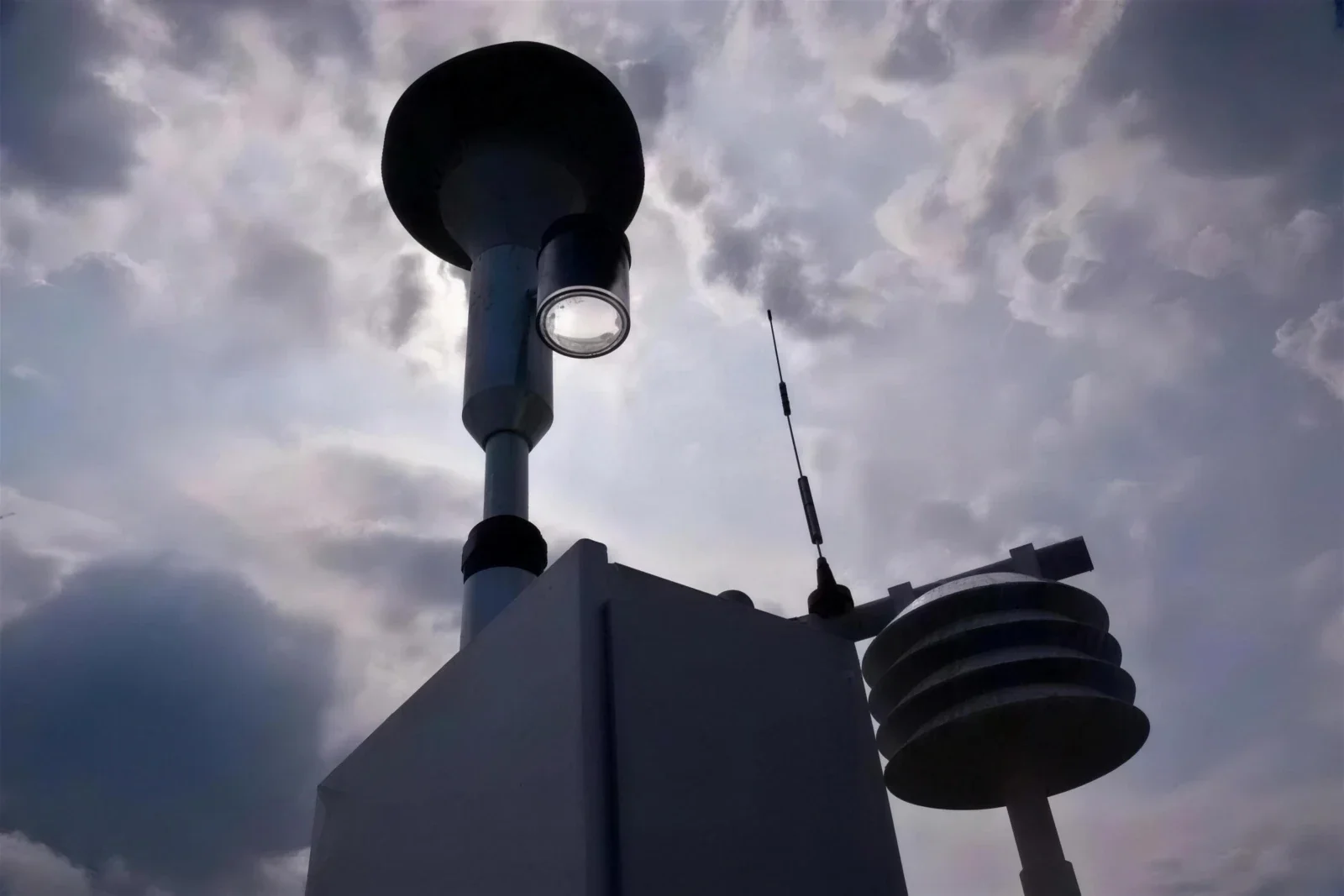 Air-monitoring equipment seen close up against a dramatic cloudy sky